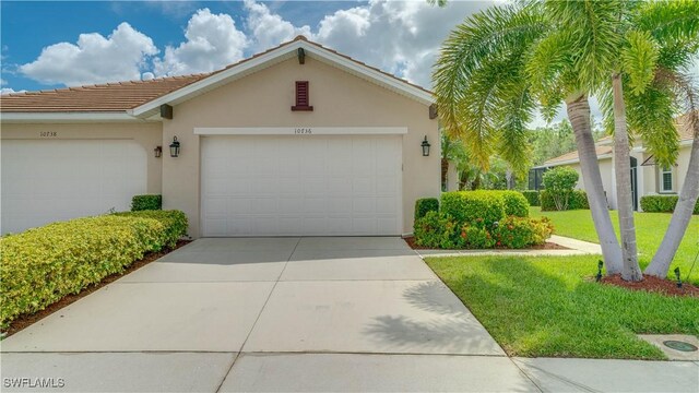 view of front of property featuring a garage and a front yard