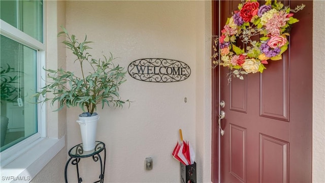 property entrance with stucco siding