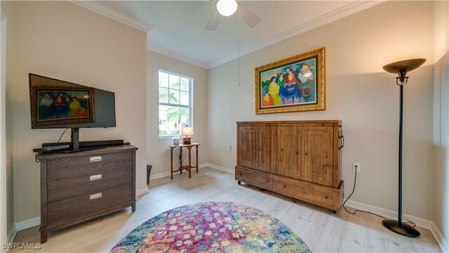 living area with ceiling fan, crown molding, and light hardwood / wood-style floors