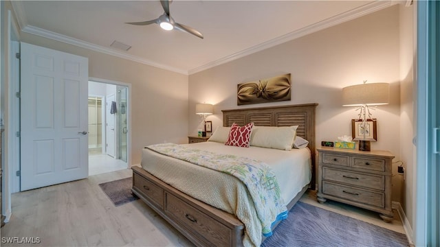 bedroom featuring ceiling fan, connected bathroom, crown molding, and light wood-type flooring