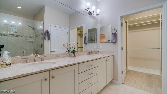 bathroom featuring vanity and an enclosed shower