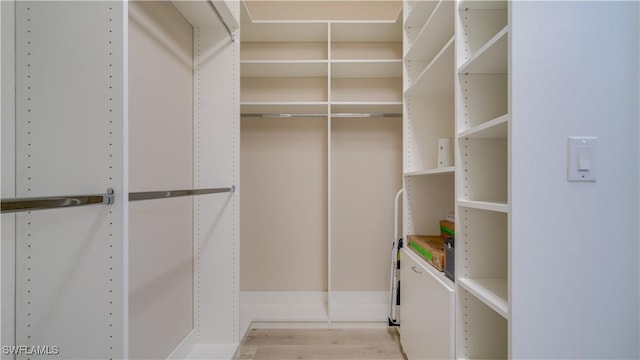 spacious closet with light hardwood / wood-style floors