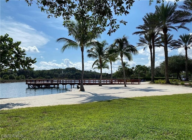 surrounding community with a lawn and a water view