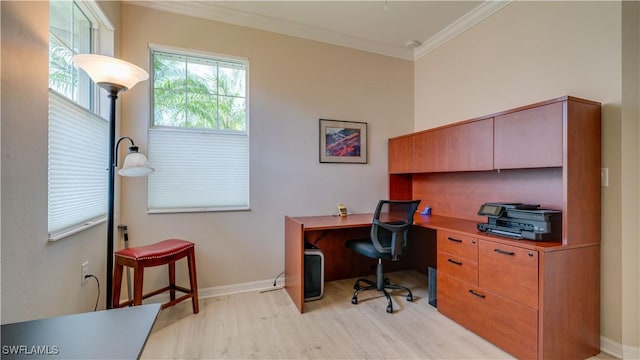 home office with light wood-type flooring, baseboards, and crown molding