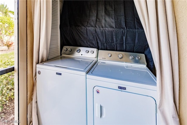 washroom featuring washer and clothes dryer