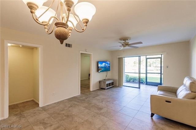 living room with ceiling fan with notable chandelier