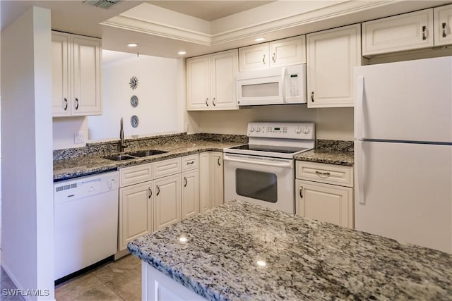 kitchen featuring white cabinetry, white appliances, sink, and dark stone counters