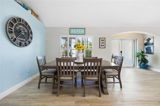 dining room featuring french doors and light hardwood / wood-style floors