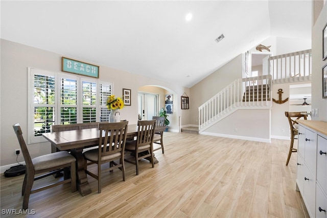 dining room with light hardwood / wood-style floors and vaulted ceiling