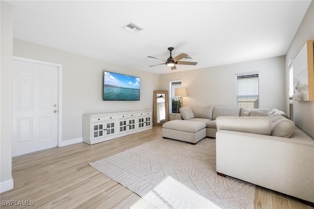 living room featuring ceiling fan and light wood-type flooring