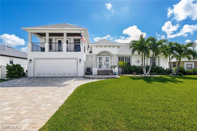 view of front facade featuring a balcony, french doors, a front lawn, and a garage