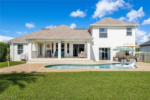 back of property with a yard, outdoor lounge area, ceiling fan, and a patio area