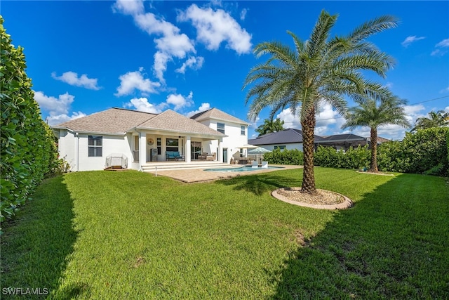 back of house featuring a patio and a lawn