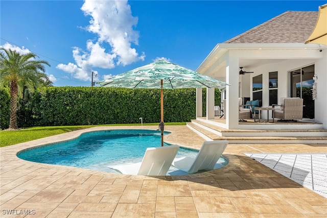 view of pool featuring ceiling fan and a patio area