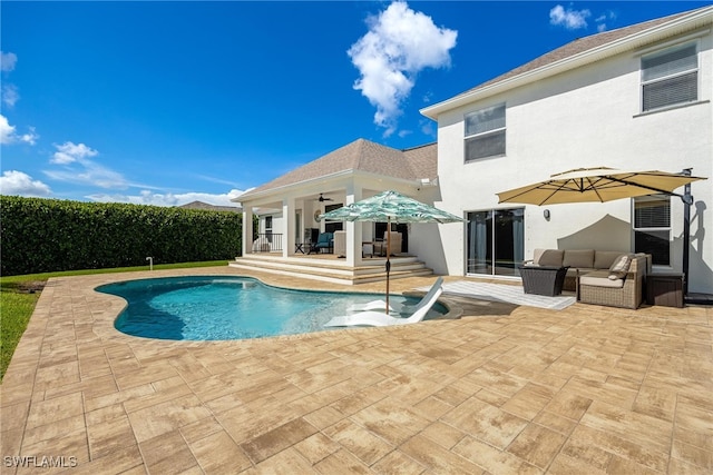 view of pool featuring ceiling fan and a patio