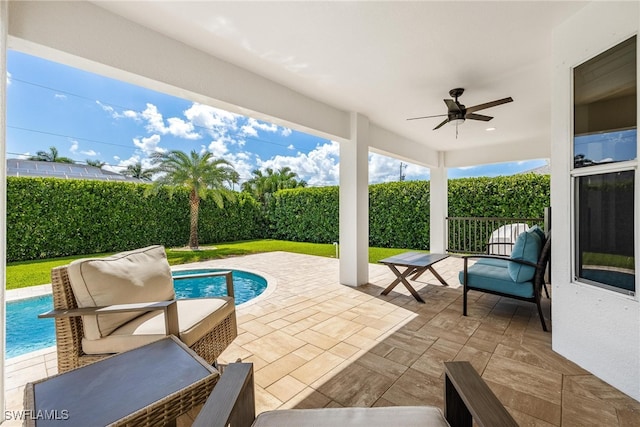 view of patio featuring a fenced in pool, outdoor lounge area, and ceiling fan