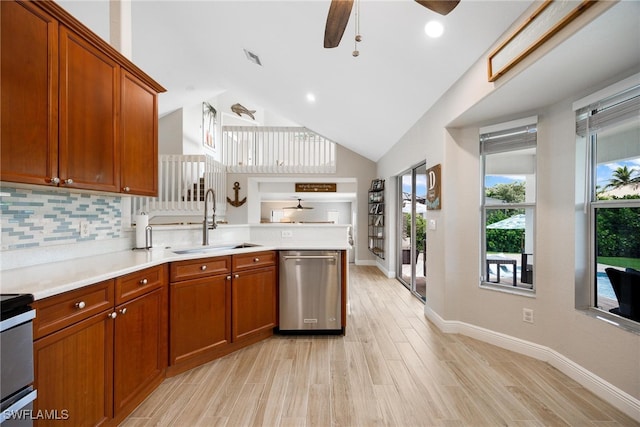 kitchen featuring ceiling fan, sink, kitchen peninsula, light hardwood / wood-style floors, and appliances with stainless steel finishes