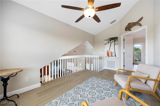 living area with ceiling fan, high vaulted ceiling, and light hardwood / wood-style floors