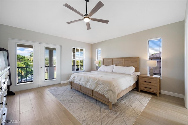 bedroom with multiple windows, ceiling fan, light hardwood / wood-style floors, and access to exterior