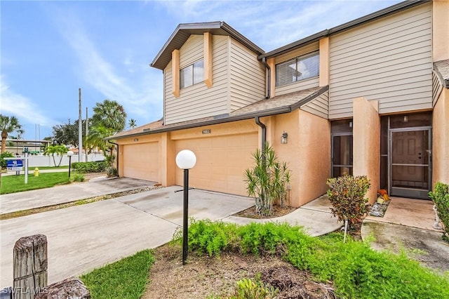 11653 Pointe Circle Dr, Fort Myers, FL 33908 - view of side of home with a garage, concrete driveway, and stucco siding