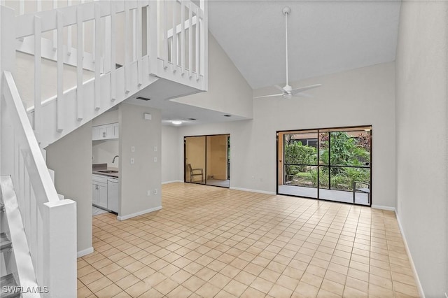 11653 Pointe Circle Dr, Fort Myers, FL 33908 - unfurnished living room with high vaulted ceiling, a ceiling fan, stairway, and light tile patterned floors