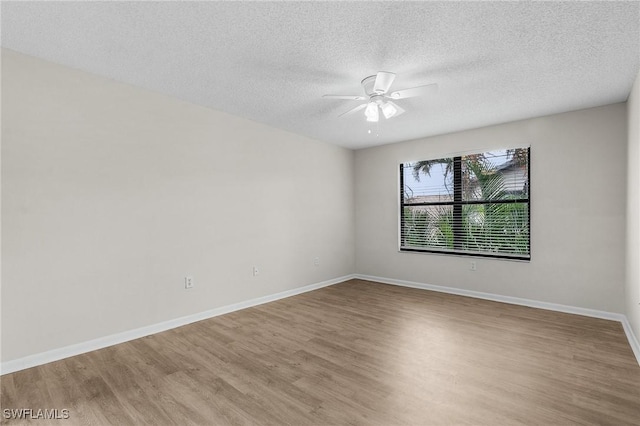 unfurnished room with ceiling fan, light hardwood / wood-style floors, and a textured ceiling