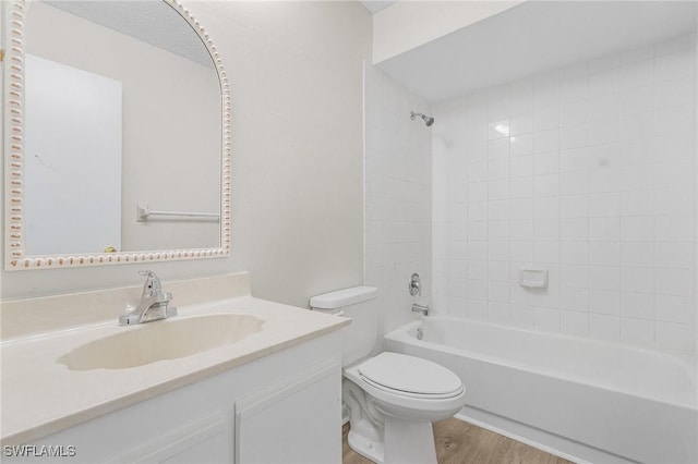 full bathroom featuring wood-type flooring, vanity, toilet, and tiled shower / bath combo