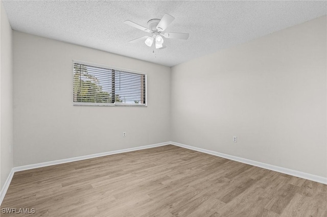 spare room with a textured ceiling, light hardwood / wood-style floors, and ceiling fan