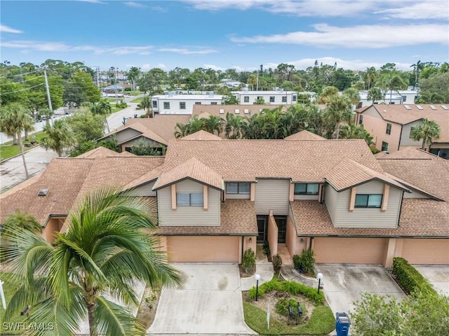 11653 Pointe Circle Dr, Fort Myers, FL 33908 - townhome / multi-family property featuring an attached garage, driveway, and roof with shingles