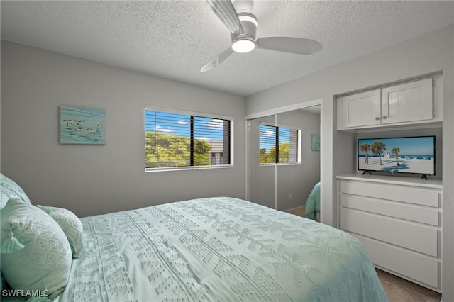 bedroom featuring a textured ceiling, ceiling fan, and a closet