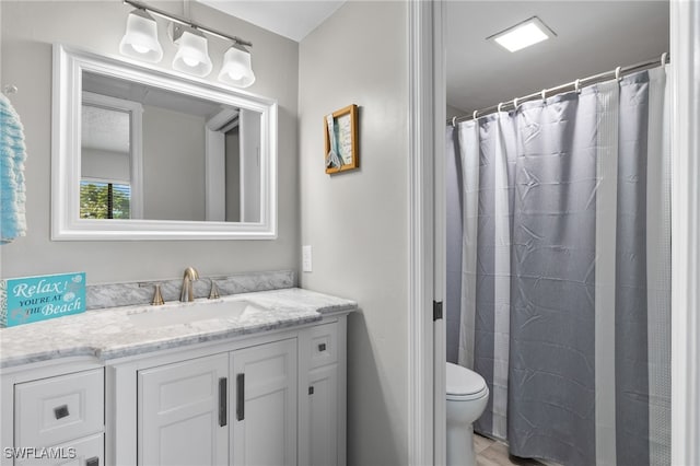 bathroom with wood-type flooring, vanity, and toilet