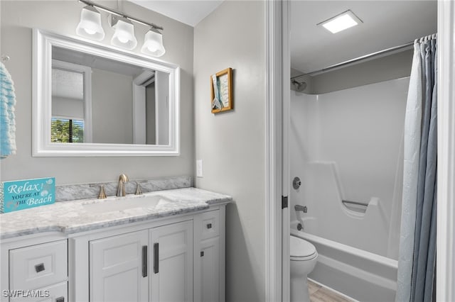 full bathroom with vanity, hardwood / wood-style floors, toilet, and shower / bath combo