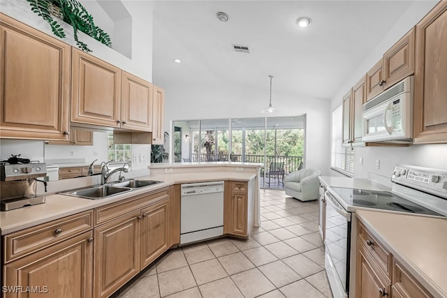 kitchen featuring sink, kitchen peninsula, lofted ceiling, white appliances, and light tile patterned floors