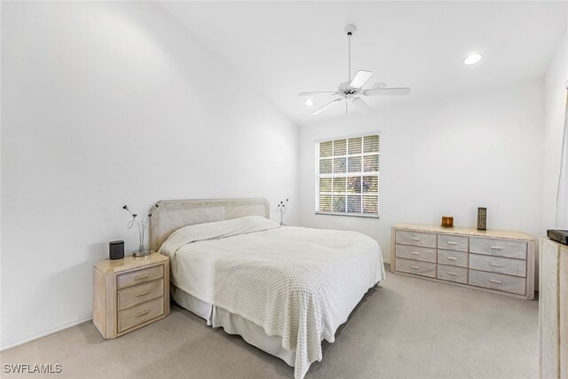 bedroom featuring ceiling fan, light colored carpet, and lofted ceiling