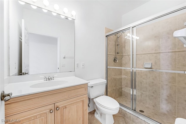 bathroom featuring an enclosed shower, vanity, toilet, and tile patterned floors