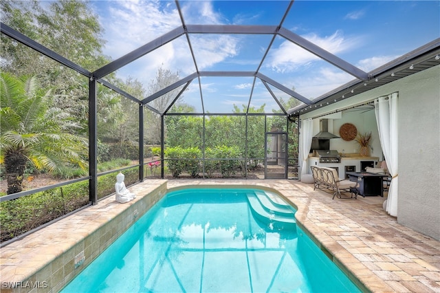 view of pool with a lanai, a patio area, and a grill