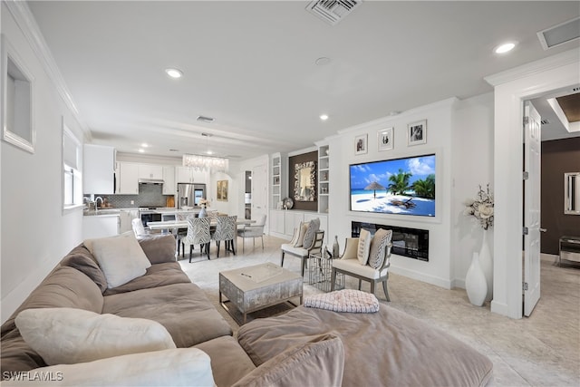 tiled living room featuring a chandelier and ornamental molding