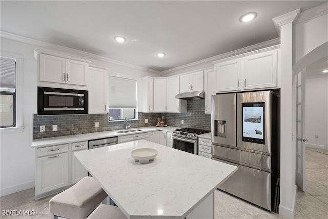 kitchen with white cabinetry, a kitchen island, stainless steel appliances, and sink