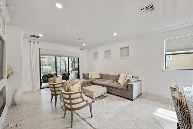 tiled living room featuring ornamental molding