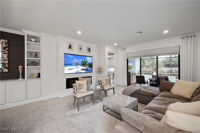 living room with built in features and crown molding