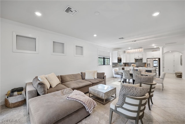 tiled living room featuring ornamental molding