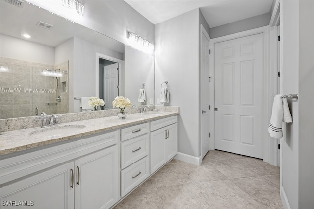 bathroom featuring tile patterned flooring, a shower with door, and vanity