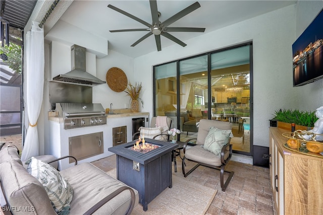 view of patio / terrace with an outdoor living space with a fire pit, grilling area, sink, exterior kitchen, and ceiling fan