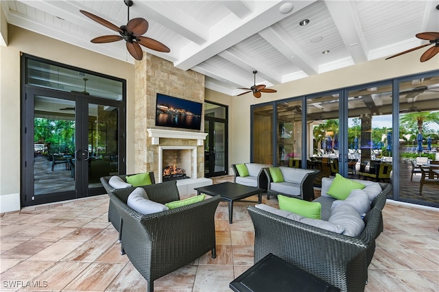 view of patio featuring an outdoor living space with a fireplace and ceiling fan