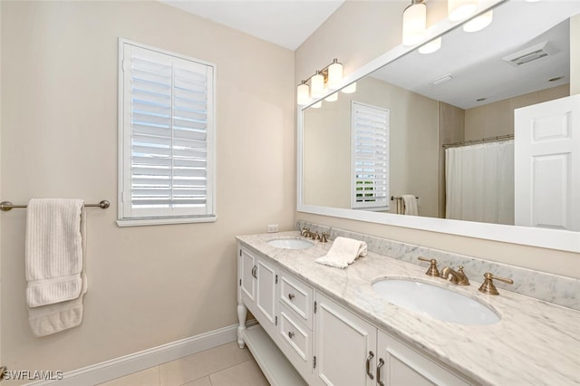 bathroom with tile patterned flooring, vanity, and plenty of natural light