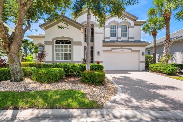 mediterranean / spanish-style house with a garage