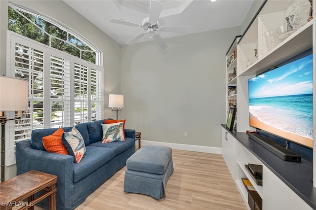 living room featuring ceiling fan, light hardwood / wood-style flooring, and a healthy amount of sunlight