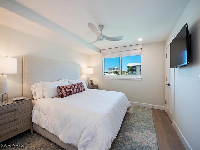 bedroom with ceiling fan and dark hardwood / wood-style floors