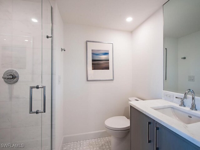 bathroom featuring walk in shower, vanity, toilet, and tile patterned floors