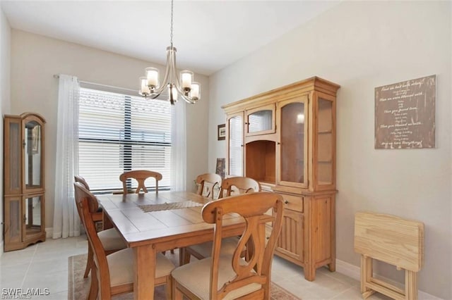 tiled dining space featuring an inviting chandelier